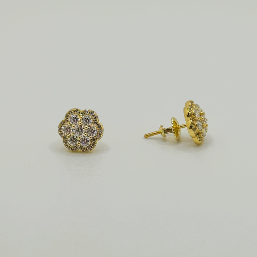A pair of gold stud earrings with a small cluster of clear pavé stones, shown on a plain light gray background. One earring is facing forward, and the other is turned to show the post and backing.