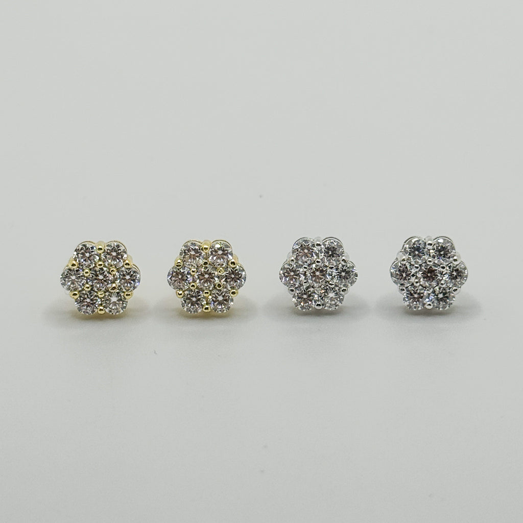 Four small pavé stud earrings arranged in a row on a light gray background. Two earrings have a yellow gold-tone setting with clear stones, and two have a silver-tone setting with clear stones.