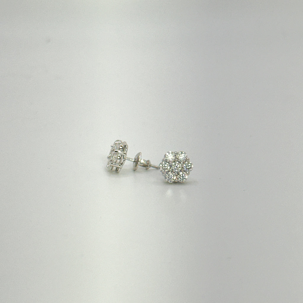 A pair of silver stud earrings with clear gemstones, displayed on a plain light gray background.